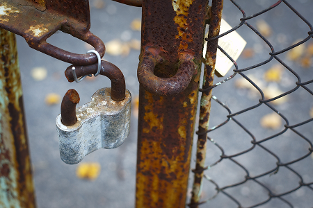 Rusty gate with a padlock